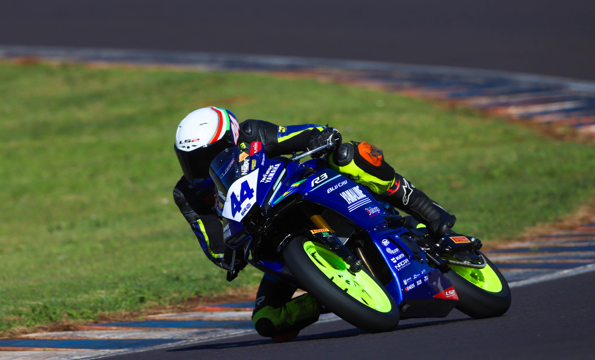 Yamaha R3 number 44 knee down on the exit of a corner