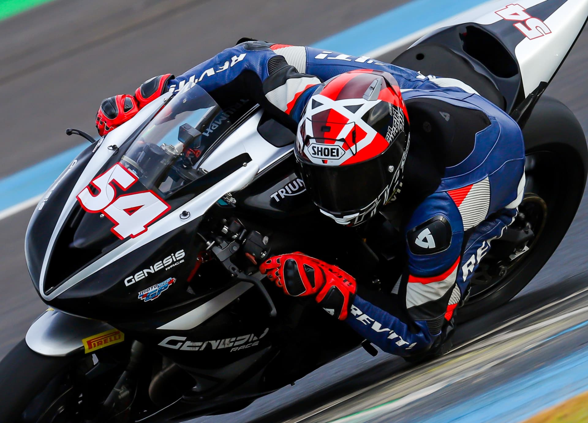 Triumph rider number 54 hard on the brakes at Moto1000GP