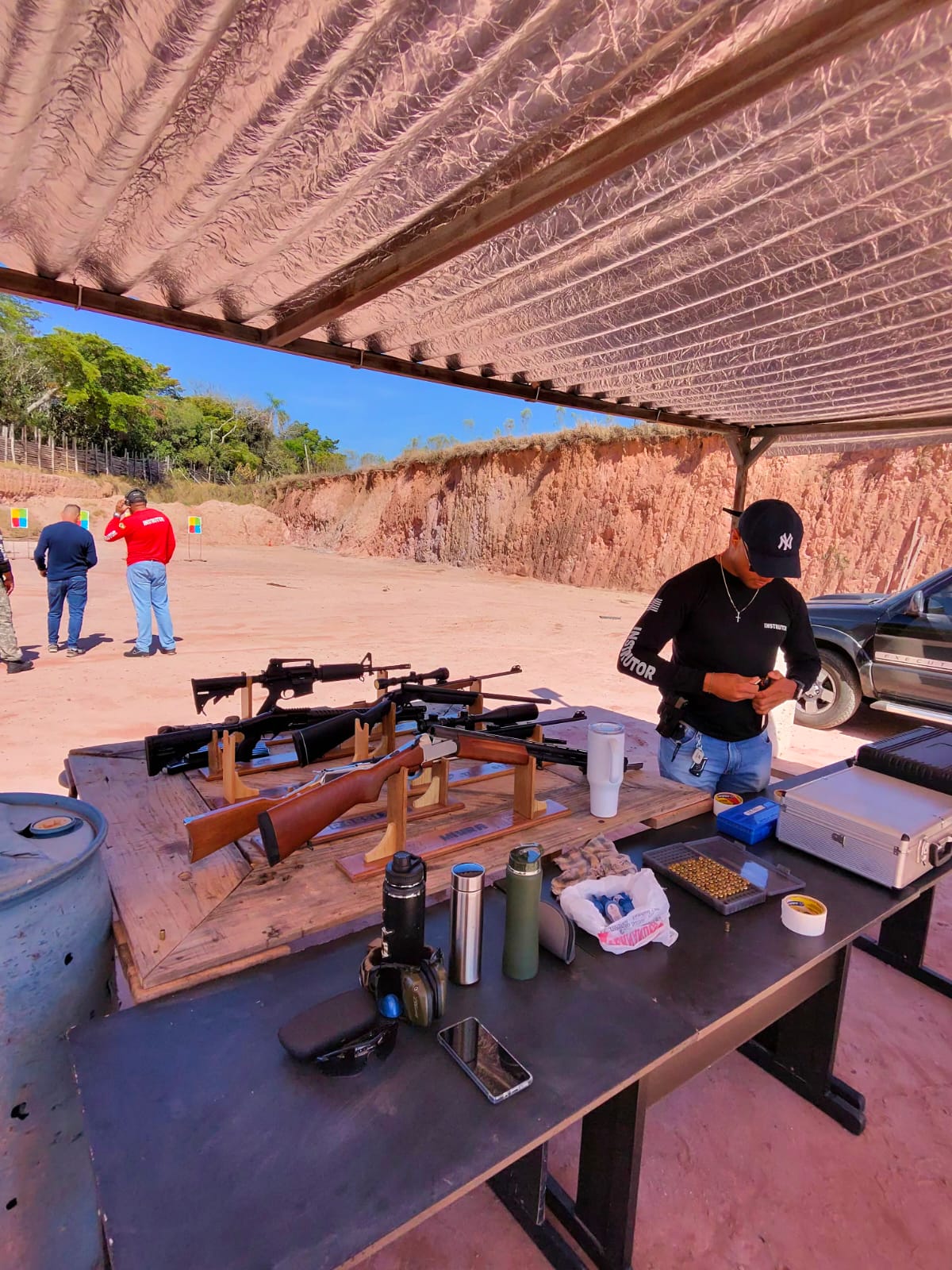 Instructor loading magazines at the training range bench