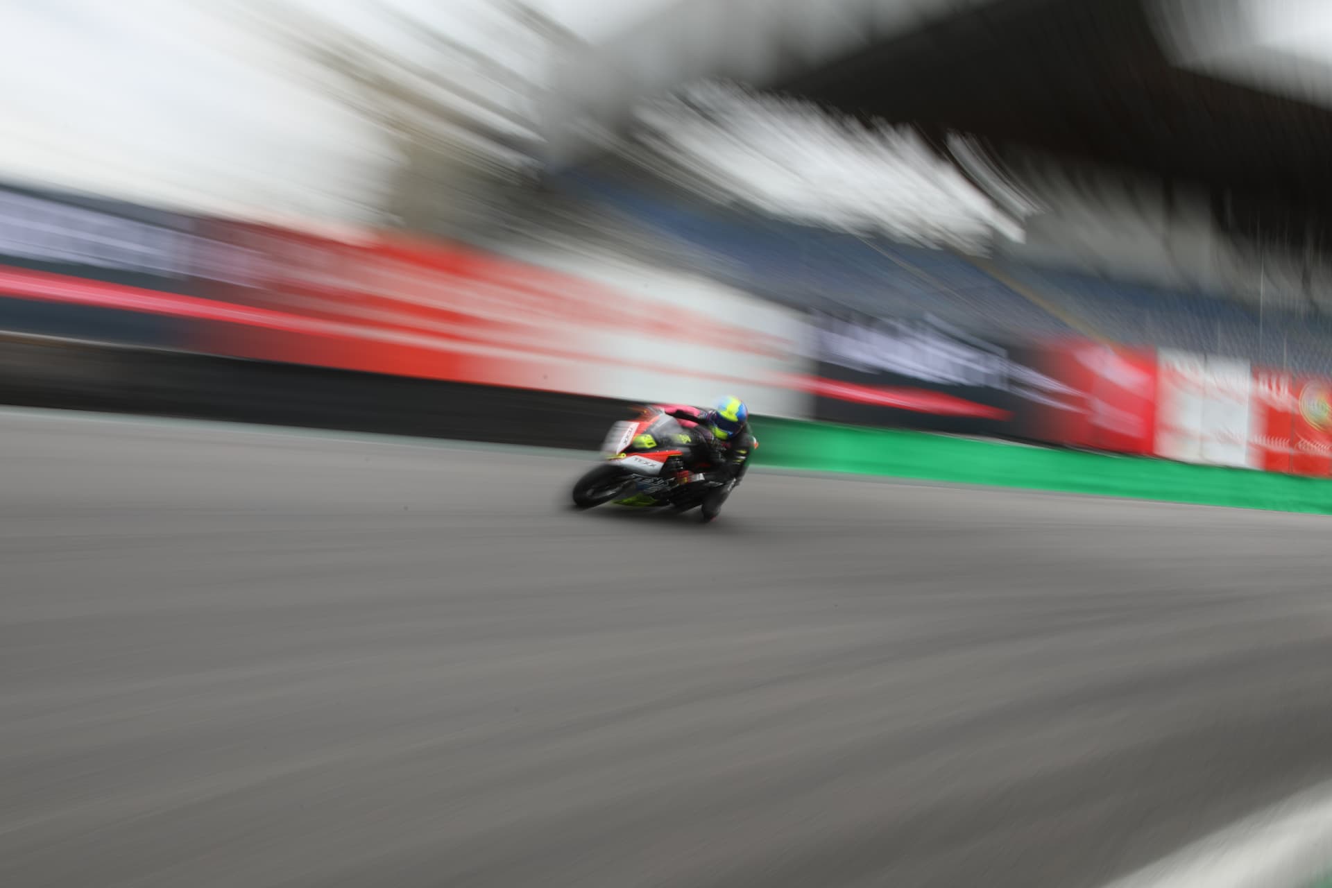 Panning shot of a rider blurring past the grandstands