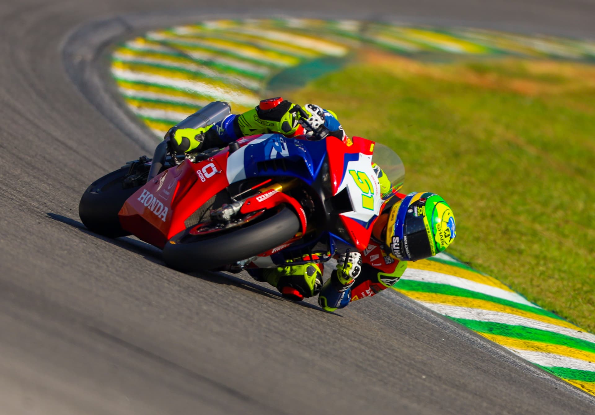 Honda superbike at full lean over the kerbs