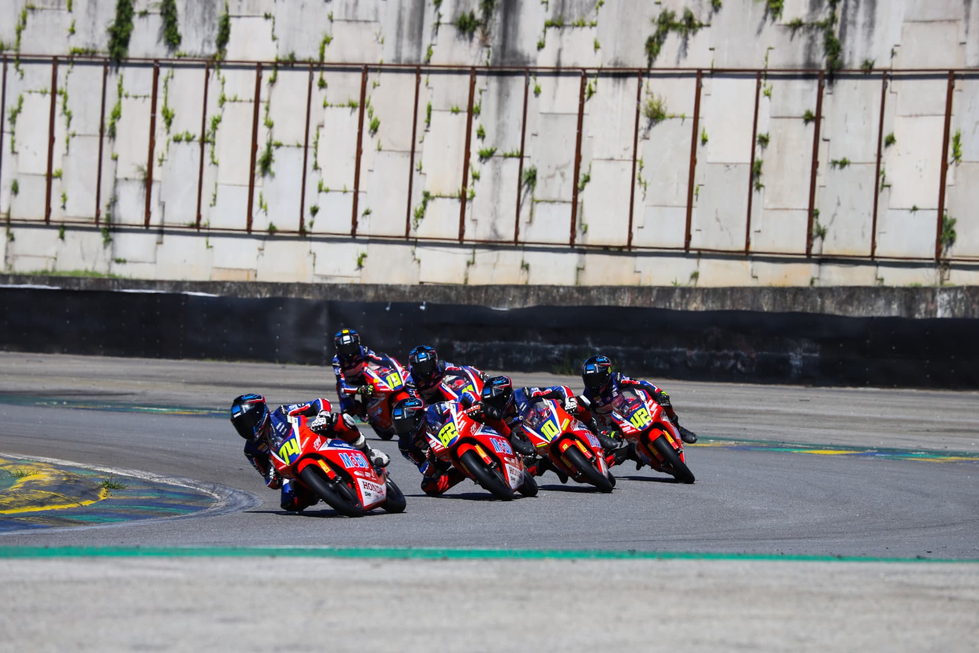 Pack of Honda Racing riders battling into the corner