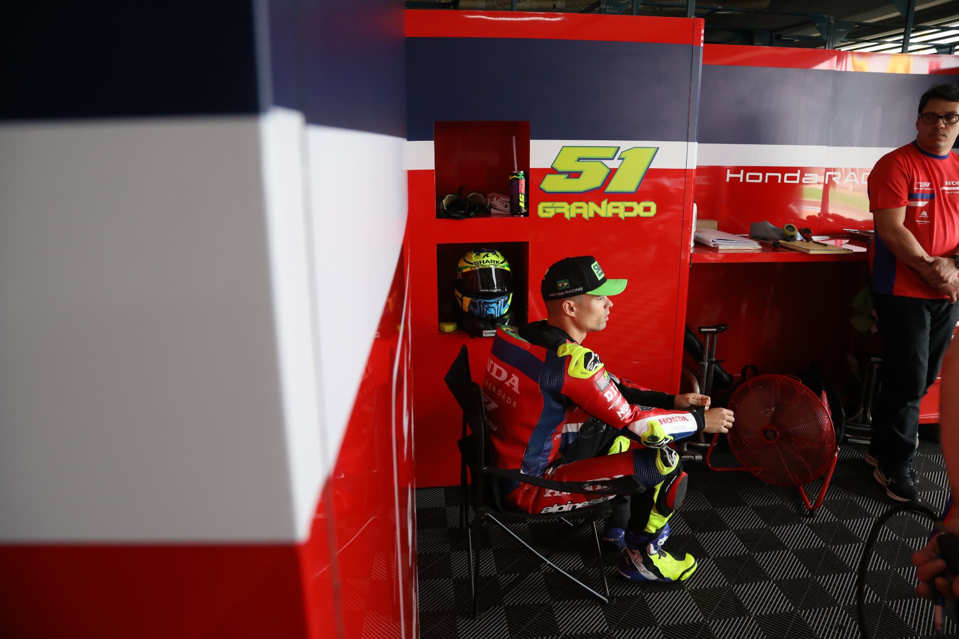 Rider Granado cooling down by the fan in the Honda Racing garage
