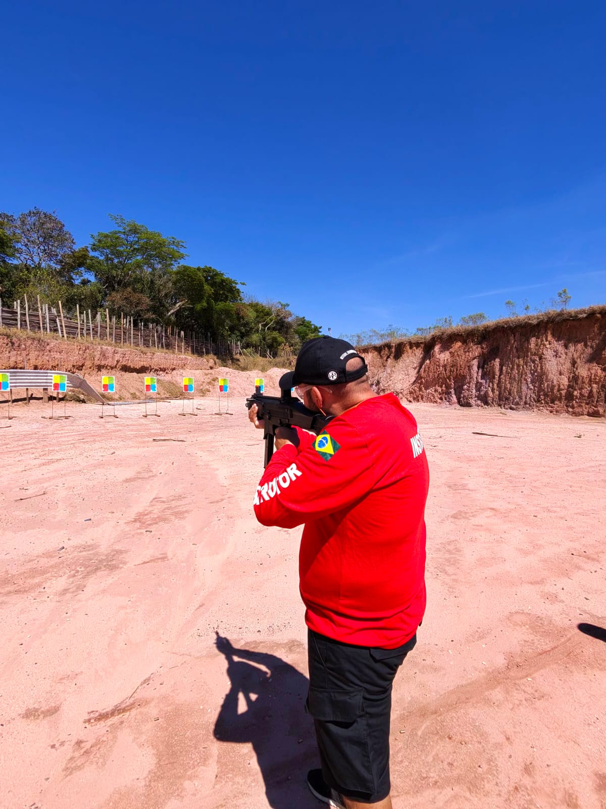 Shooter lining up on colour targets at an outdoor range