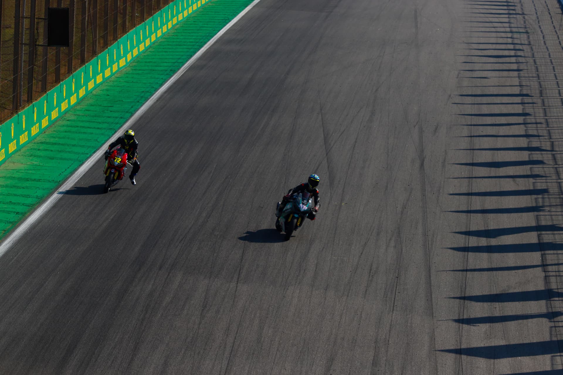 Two riders on the main straight seen from above