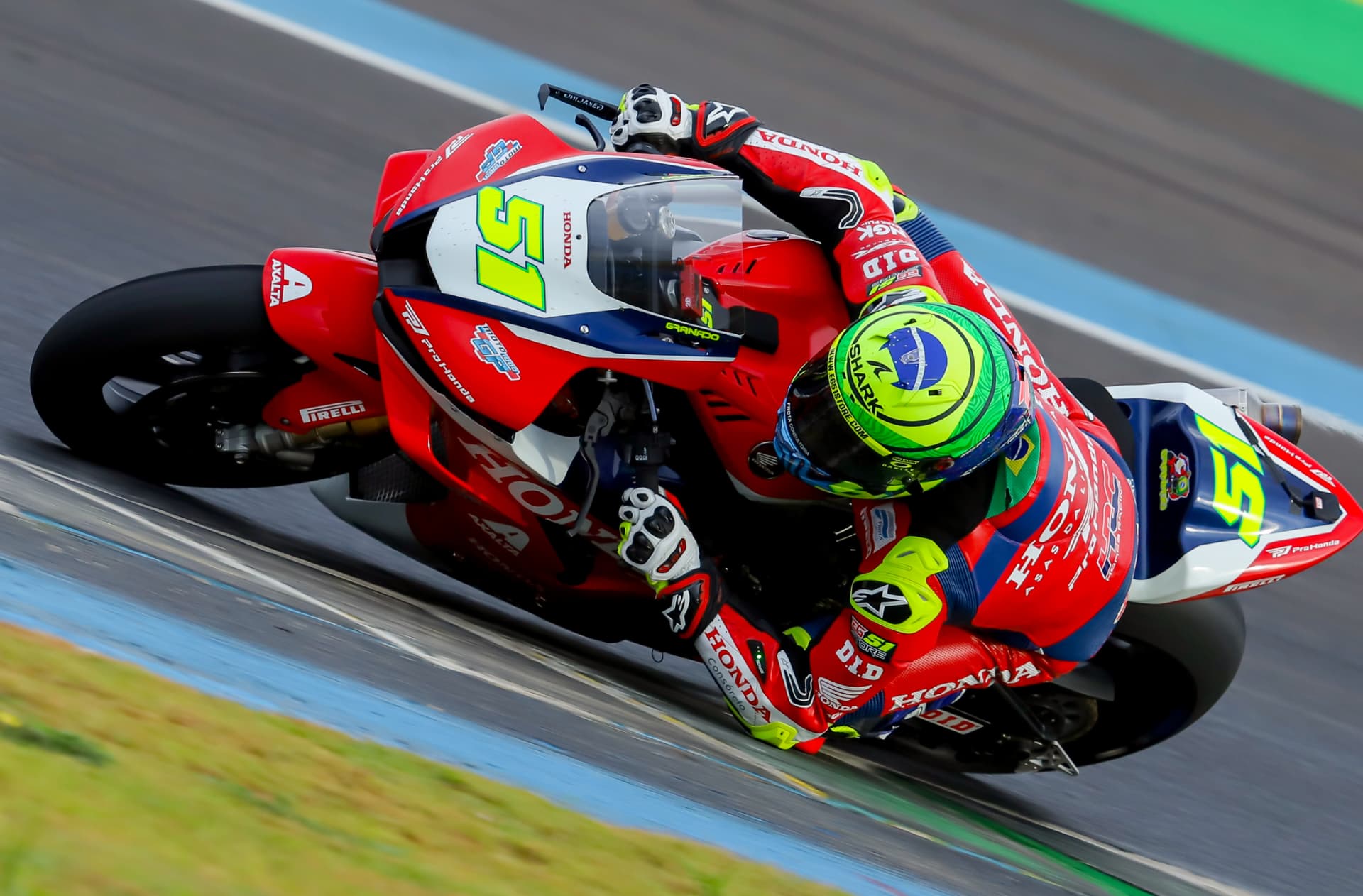 Honda Racing rider #51 hard on the lean through a fast corner