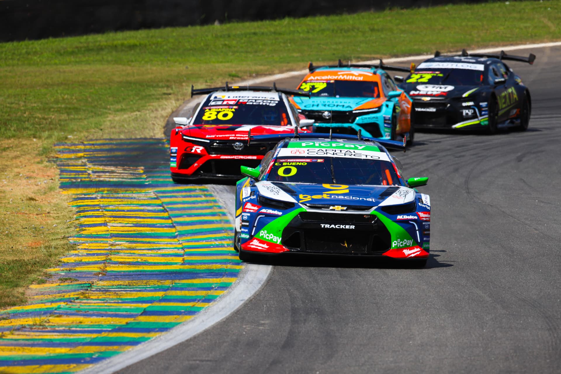 Chevrolet Tracker leading a pack of stock cars over the kerbs
