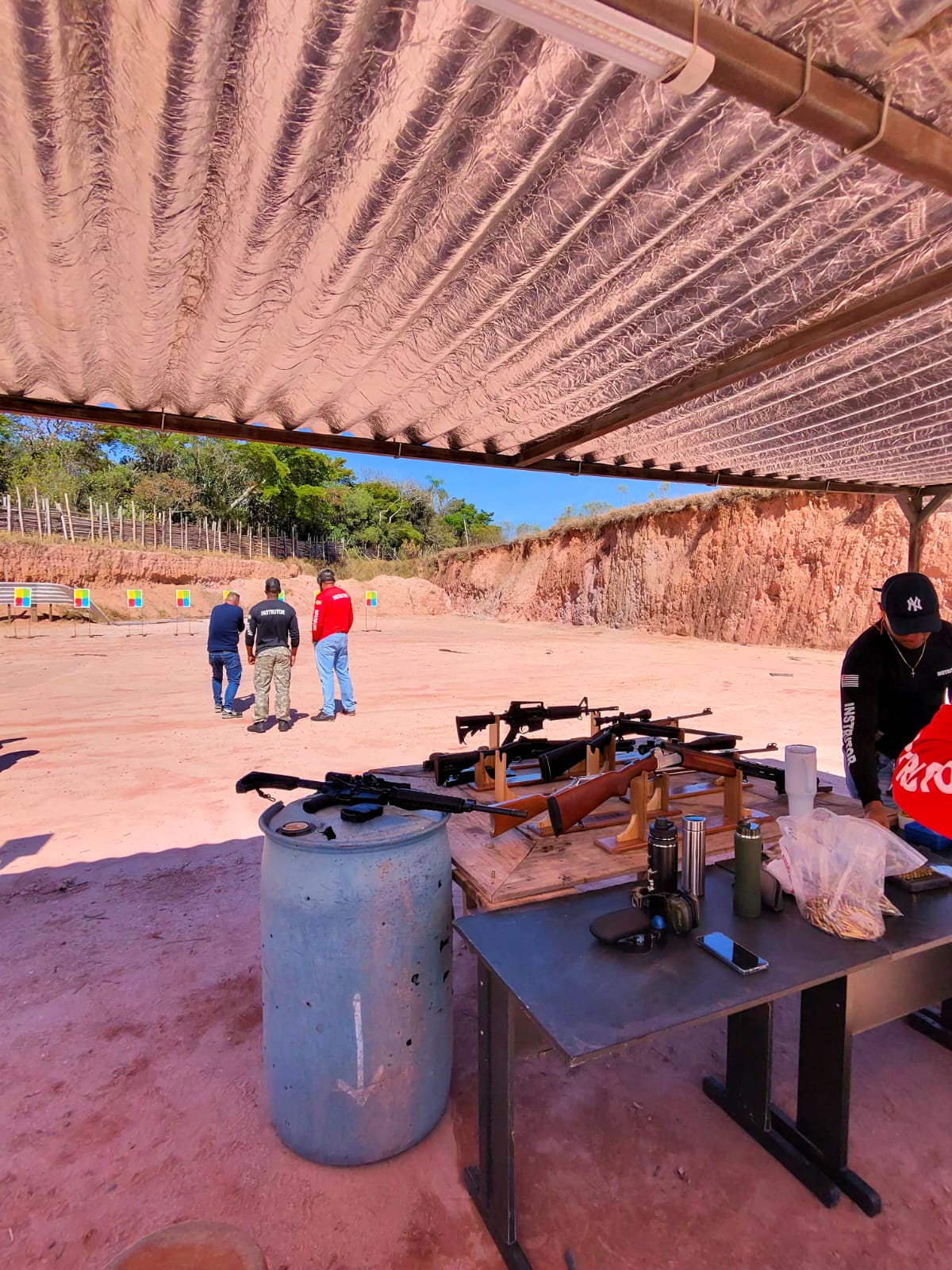 Range shelter with rifles staged on the bench before a session